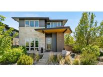 Modern two-story home with stone and brick accents, professionally landscaped front yard at 9154 E 37Th Ave, Denver, CO 80238