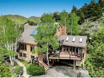 Mountain home with stone accents, large deck, and stunning views at 34127 Cactus Dr, Evergreen, CO 80439