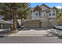 Charming townhome featuring a two-car garage, balcony, and stone accents at 1356 Carlyle Park Cir, Highlands Ranch, CO 80129