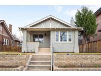 Charming home featuring a brick facade, manicured lawn, and inviting front porch at 764 S Corona St, Denver, CO 80209