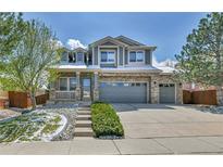 Charming two-story home with brick accents and a three-car garage at 20948 E Hamilton Ave, Aurora, CO 80013