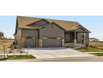 Charming single-Gathering home featuring a two-car garage, covered porch, and stone accents at 23774 E 36Th Pl, Aurora, CO 80019