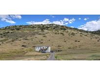 Ranch-style home on hillside lot with spacious yard and mountain views at 5876 High Toll Trl, Morrison, CO 80465