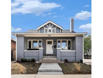 Charming home with a gray brick facade, well-manicured lawn, and a classic architectural design at 595 N Lafayette St, Denver, CO 80218