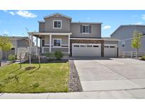 Charming two-story home with a well-maintained lawn and a three-car garage at 5166 Trails Edge Ln, Castle Rock, CO 80104