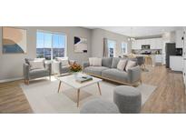 Bright living room features neutral colors, plush seating, and an open layout to the kitchen at 5166 Trails Edge Ln, Castle Rock, CO 80104