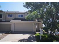 Charming townhome with a two-car garage, mature tree, and well-maintained landscaping at 10966 Josephine St, Northglenn, CO 80233