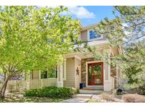 Charming two-story home with a welcoming front porch and beautiful landscaping at 11367 S Blackthorn Ct, Parker, CO 80134