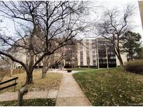 Condo building with green space and a sidewalk at 6960 E Girard Ave # 404, Denver, CO 80224