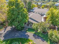 Stunning aerial view of the home showcasing its mature trees, circular driveway, and well-manicured yard at 6480 W 60Th Ave, Arvada, CO 80003