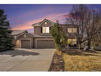 Inviting two-story home featuring a three-car garage and meticulously landscaped front yard at 13653 Windom Ln, Broomfield, CO 80023