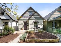 Charming home featuring a front patio, unique architectural details, and a well-maintained yard at 3375 W 37Th Ave, Denver, CO 80211