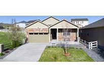 Charming single-story home with a well-manicured lawn and a welcoming covered front porch at 5996 Sun Mesa Cir, Castle Rock, CO 80104