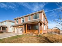 Two-story stucco house featuring a charming front porch and arched windows at 20341 E 48Th Pl, Denver, CO 80249