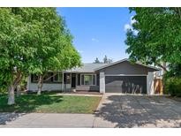 Charming single-story home with a well-maintained lawn, mature trees, and a two-car garage at 2646 S Pagosa Way, Aurora, CO 80013
