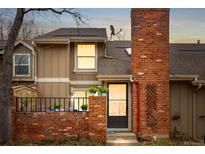 Charming two-story townhome featuring a brick front facade and a cozy front patio at 11689 Elk Head Range Rd, Littleton, CO 80127