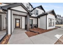Stunning exterior of a modern two-story home with black trim and a welcoming front porch at 8530 W 52Nd Ave # C2, Arvada, CO 80002
