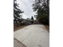 Charming home featuring an extra long driveway and a welcoming exterior at 7863 S Harrison Cir, Centennial, CO 80122