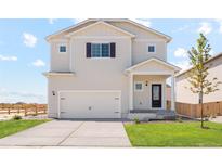 Charming two-story home featuring a two-car garage, well-maintained lawn, and classic architectural details at 7322 Green River Ave, Frederick, CO 80530