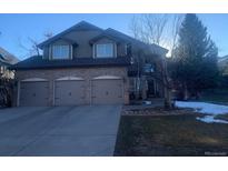 Charming two-story home featuring a three-car garage and a beautifully landscaped yard at 12 Summit Ash, Littleton, CO 80127