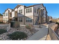 Charming condo featuring neutral siding, rock landscaping, and a concrete walkway leading to the entrance at 4578 Copeland Cir # 203, Highlands Ranch, CO 80126