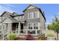 Charming gray two-story home with stone accents and a cozy front porch at 3765 W 88Th Ct, Westminster, CO 80031