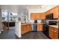 Bright kitchen with stainless steel appliances and wood cabinets at 18242 E Bethany Pl, Aurora, CO 80013