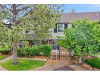 Attractive townhouse featuring a well-maintained lawn and mature trees for added curb appeal and privacy at 9930 W Progress Pl, Littleton, CO 80123