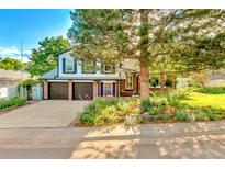Charming two-story home with a well-manicured lawn and a two car garage showcasing its inviting curb appeal at 7681 S Jellison St, Littleton, CO 80127