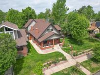 Charming two-story brick home with a well-manicured lawn and beautiful landscaping at 1731 S Ogden St, Denver, CO 80210