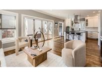 Bright living room boasts hardwood floors, neutral tones, and sliding glass doors to an outdoor patio at 325 S High St, Denver, CO 80209