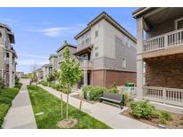 Charming two-story townhome with a landscaped front yard, bench, and inviting curb appeal at 12886 E Wesley Pl, Aurora, CO 80014