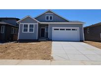Charming single-story home features a two-car garage and classic architectural details at 6034 Keyser Pl, Brighton, CO 80601