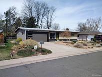Ranch-style home with updated facade and landscaping at 209 Reed St, Lakewood, CO 80226