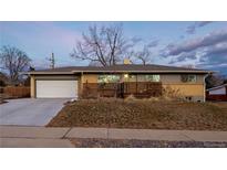 Charming single-story home features an attached garage and mature landscaping at 2904 S Raleigh St, Denver, CO 80236