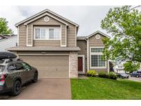 Charming two-story home featuring well-maintained lawn, garage and brick-accented entryway at 3101 Goldeneye Pl, Superior, CO 80027