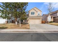 Charming two-story home featuring a well-manicured lawn and a two-car garage at 3214 S Bahama St, Aurora, CO 80013