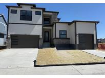 Modern two-story home with a two-car garage and stone accents at 898 Coal Bank Trl, Castle Rock, CO 80104
