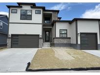 Modern two-story home with dark trim, stone accents, and a two-car garage at 898 Coal Bank Trl, Castle Rock, CO 80104
