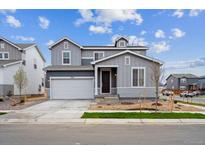 Charming two-story home with a two-car garage and well-manicured lawn in a suburban neighborhood at 1352 Orchard St, Brighton, CO 80601
