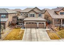 Charming two-story home with a well-maintained lawn and a spacious two-car garage and tile roof at 14097 Double Dutch Cir, Parker, CO 80134