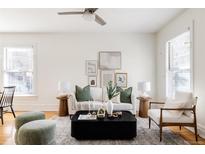Bright living room featuring a white sofa, stylish decor, and large windows at 1000 N Ogden St, Denver, CO 80218