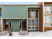 Two-story condo with an olive-colored exterior and large multi-paned windows at 4950 Homestead Pl # 23, Thornton, CO 80229