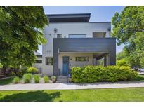 Contemporary home with a blue front door, modern landscaping, and a well-manicured lawn at 2898 W 22Nd Ave, Denver, CO 80211