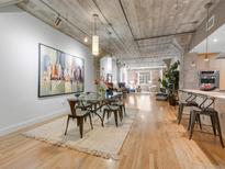 Bright dining room boasts an open floor plan, hardwood floors, and a modern table with seating for six at 1449 Wynkoop St # 305, Denver, CO 80202