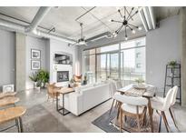 Bright, open living space with polished concrete floors, fireplace, and modern furnishings at 2899 N Speer Blvd # 203, Denver, CO 80211