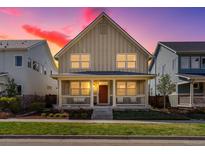 Charming two-story home featuring a cozy front porch and professionally landscaped yard at 5511 Wabash St, Denver, CO 80238