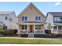 Charming two-story home with a welcoming front porch and manicured lawn at 5511 Wabash St, Denver, CO 80238