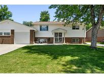 Charming two-story home with a well-maintained front yard and brick accents at 4604 Routt St, Wheat Ridge, CO 80033