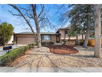 Charming home featuring manicured landscaping, rock ground cover, and mature trees in a pleasant neighborhood setting at 2078 S Quintero St, Aurora, CO 80013